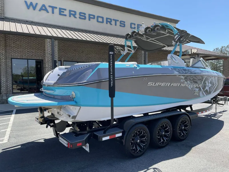 Slide: The Image of 2015 Nautique G25 boat parked outside Watersports Center. - 6