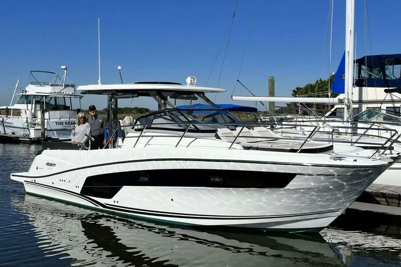 The Image of 2022 Jeanneau Leader 10.5 WA Series 2 boat docked with two people onboard. - 0