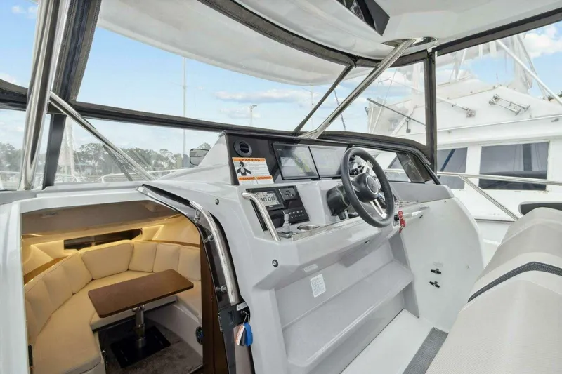 Slide: The Image of 2022 Jeanneau Leader 10.5 WA Series 2 boat interior with helm and cabin view. - 10