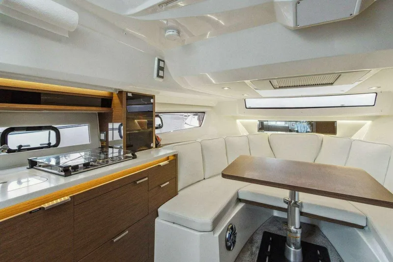 Slide: The Image of Interior of 2022 Jeanneau Leader 10.5 WA Series 2 with modern kitchen and seating area. - 11