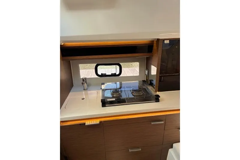 Slide: The Image of Interior of 2022 Jeanneau Leader 10.5 WA Series 2, featuring a modern kitchenette. - 13