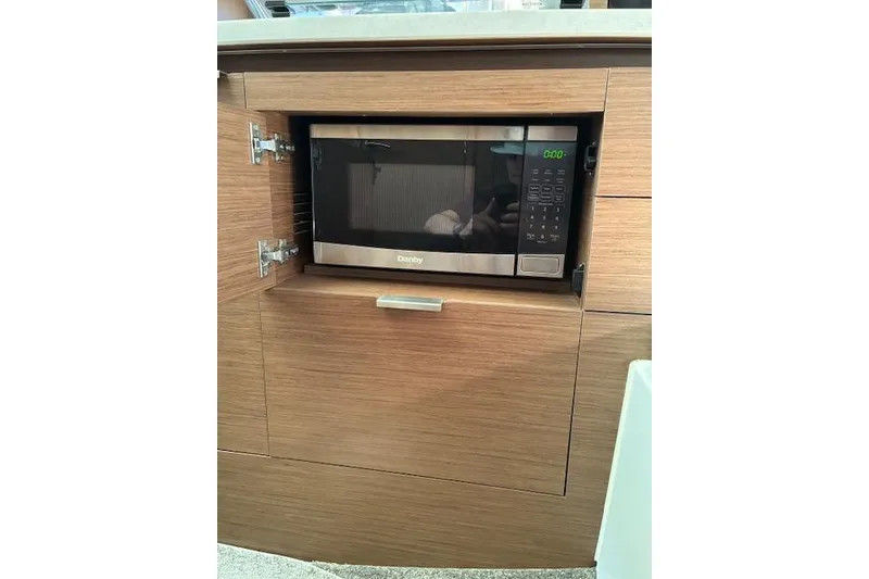 Slide: The Image of Built-in microwave in Jeanneau Leader 10.5 WA Series 2, 2022 model, wooden cabinetry. - 15