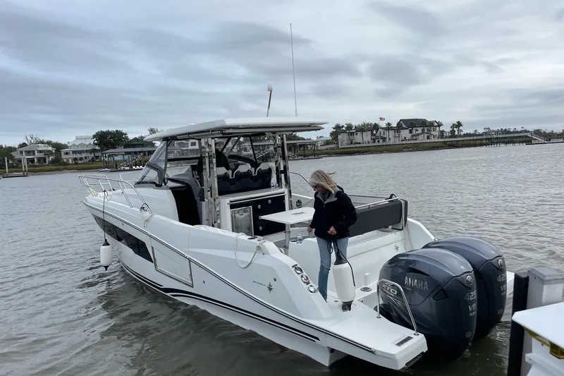Slide: The Image of 2022 Jeanneau Leader 10.5 WA Series 2 boat with Yamaha engines on a calm waterway. - 22