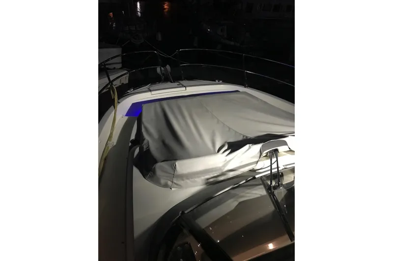 Slide: The Image of 2022 Jeanneau Leader 10.5 WA Series 2 boat at night, covered deck. - 25
