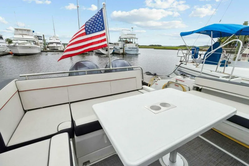 Slide: The Image of 2022 Jeanneau Leader 10.5 WA Series 2 boat with American flag at marina. - 6