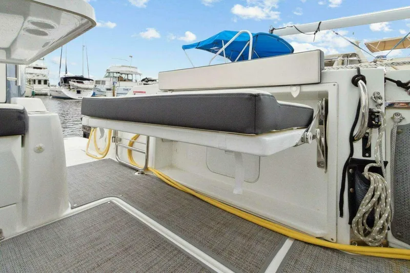 Slide: The Image of 2022 Jeanneau Leader 10.5 WA Series 2 boat interior with foldable seating and marina view. - 7