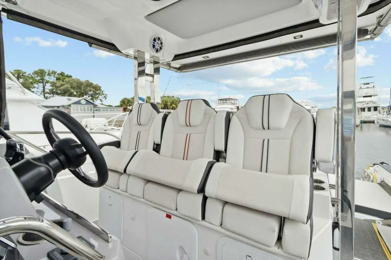 Slide: The Image of Interior of 2022 Jeanneau Leader 10.5 WA Series 2 with plush seating and steering wheel. - 8