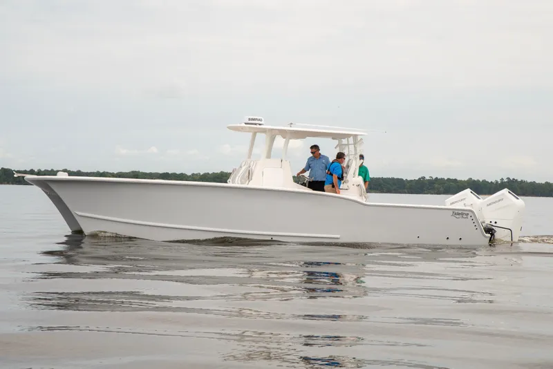 Slide: The Image of 2026 Tideline 365 Offshore boat cruising on calm waters with passengers onboard. - 12