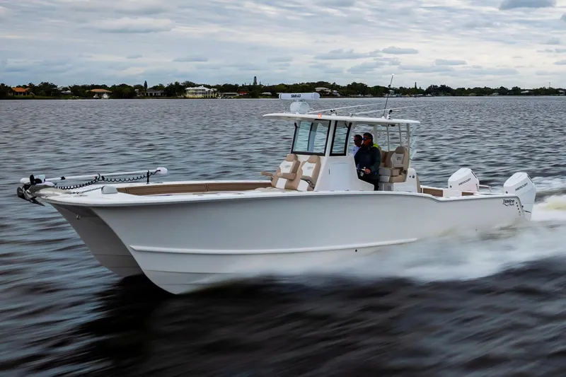 Slide: The Image of 2026 Tideline 365 Offshore boat cruising on a calm lake under a cloudy sky. - 14