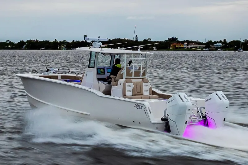 Slide: The Image of 2026 Tideline 365 Offshore boat cruising on water with dual outboard engines. - 15