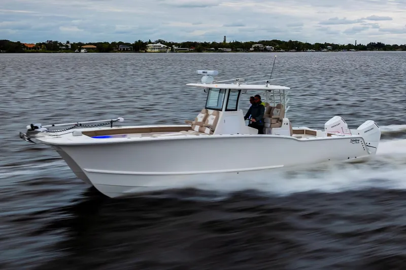 Slide: The Image of 2026 Tideline 365 Offshore boat cruising on a calm waterway. - 16