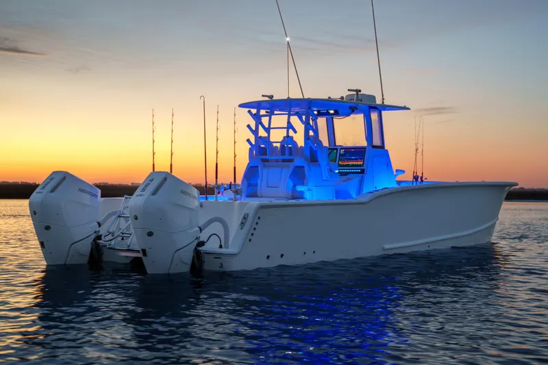 Slide: The Image of 2026 Tideline 365 Offshore boat illuminated at sunset on calm waters. - 17