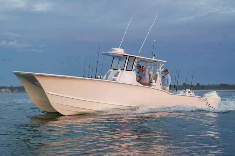 Slide: The Image of 2026 Tideline 365 Offshore boat cruising on calm waters at sunset. - 18