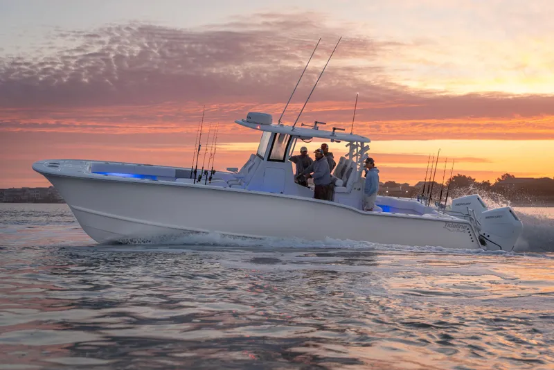 Slide: The Image of 2026 Tideline 365 Offshore boat cruising at sunset with passengers onboard. - 19