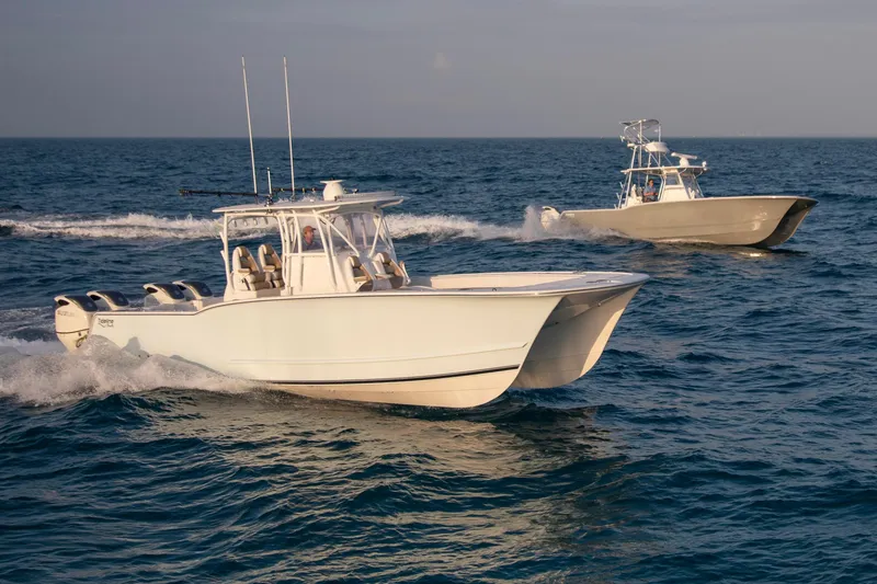 Slide: The Image of Two Tideline 365 Offshore boats cruising on open water, 2026 model. - 2