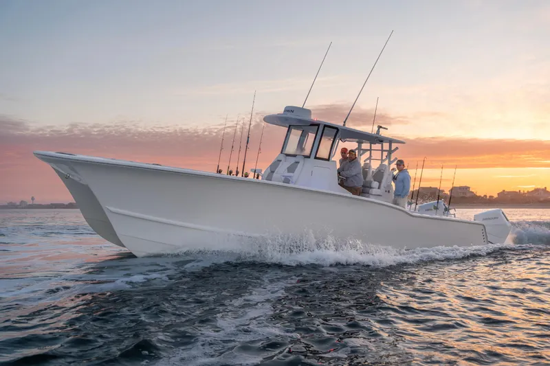Slide: The Image of 2026 Tideline 365 Offshore boat cruising at sunset with fishing rods. - 21