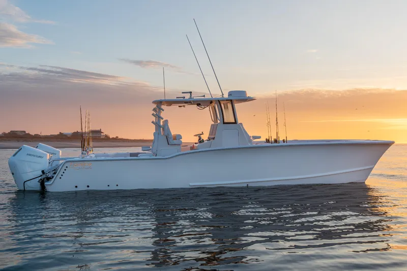 Slide: The Image of 2026 Tideline 365 Offshore boat at sunset on calm waters. - 22