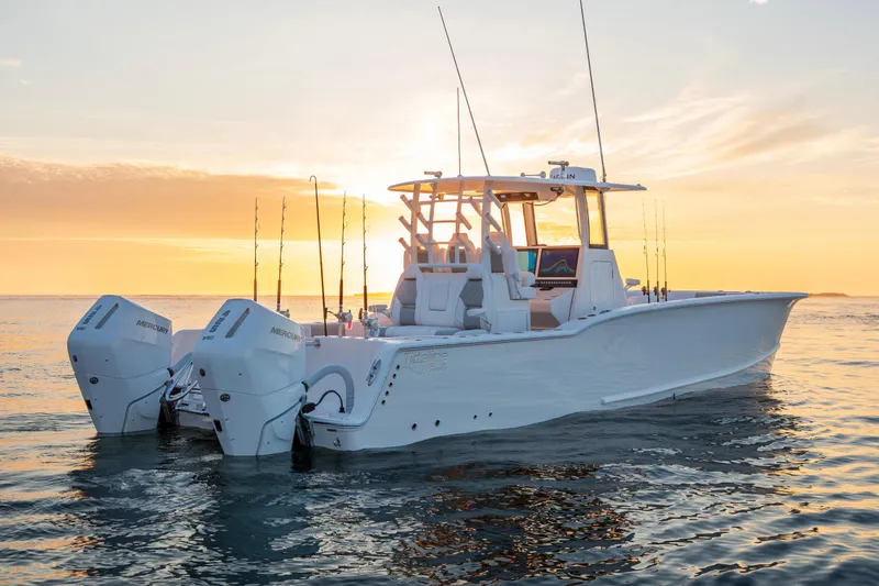 Slide: The Image of 2026 Tideline 365 Offshore boat at sunset, featuring dual Mercury engines. - 23