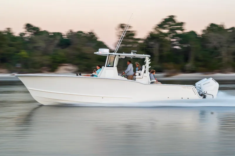 Slide: The Image of 2026 Tideline 365 Offshore boat cruising on calm water at sunset. - 27