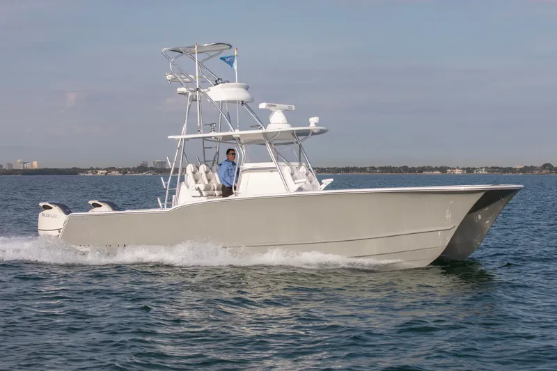 Slide: The Image of 2026 Tideline 365 Offshore boat cruising on open water, featuring dual outboard engines. - 3