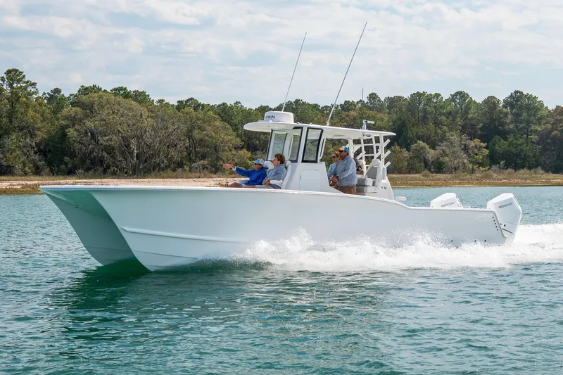 Slide: The Image of 2026 Tideline 365 Offshore boat cruising on a scenic waterway with passengers onboard. - 31