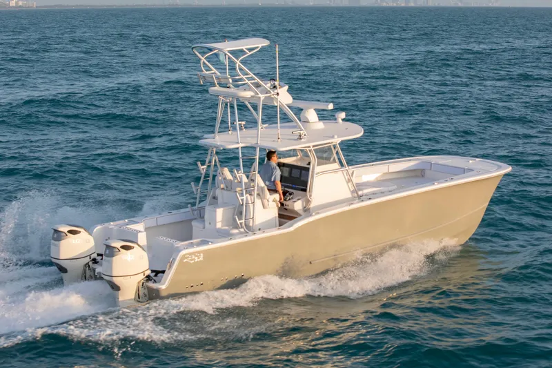 Slide: The Image of 2026 Tideline 365 Offshore boat cruising on open water, featuring dual outboard engines. - 34