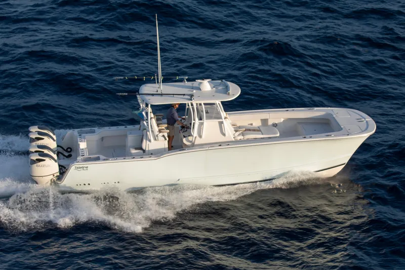 Slide: The Image of 2026 Tideline 365 Offshore boat cruising on open water, featuring triple Suzuki engines. - 36
