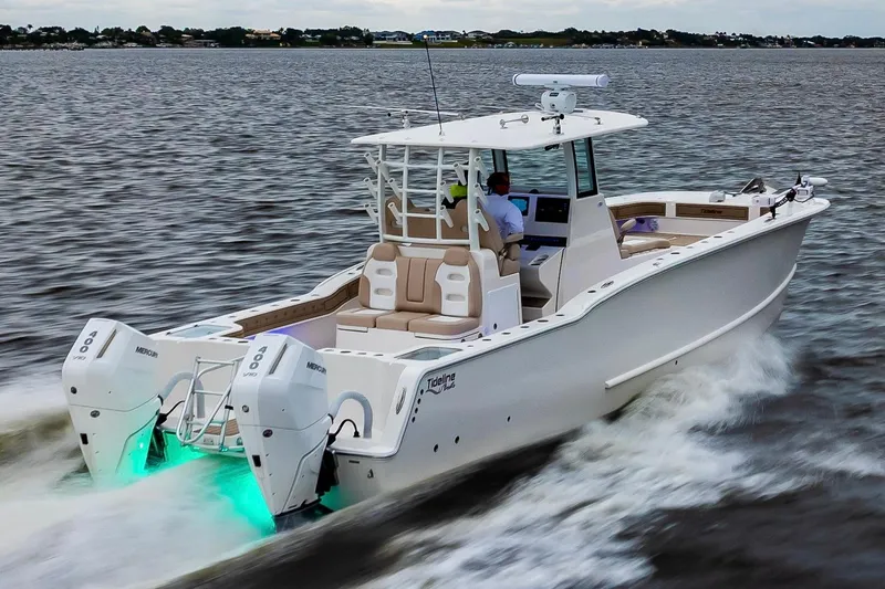 Slide: The Image of 2026 Tideline 365 Offshore boat cruising on open water with dual Mercury engines. - 37