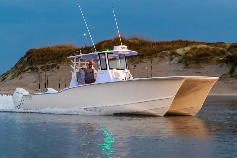 Slide: The Image of 2026 Tideline 365 Offshore boat cruising near sandy shoreline at dusk. - 39
