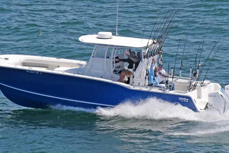 Slide: The Image of 2026 Tideline 365 Offshore boat cruising with fishing rods on open water. - 44
