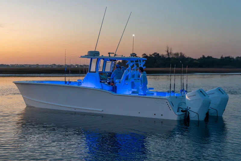 Slide: The Image of 2026 Tideline 365 Offshore boat illuminated at sunset on calm waters. - 48