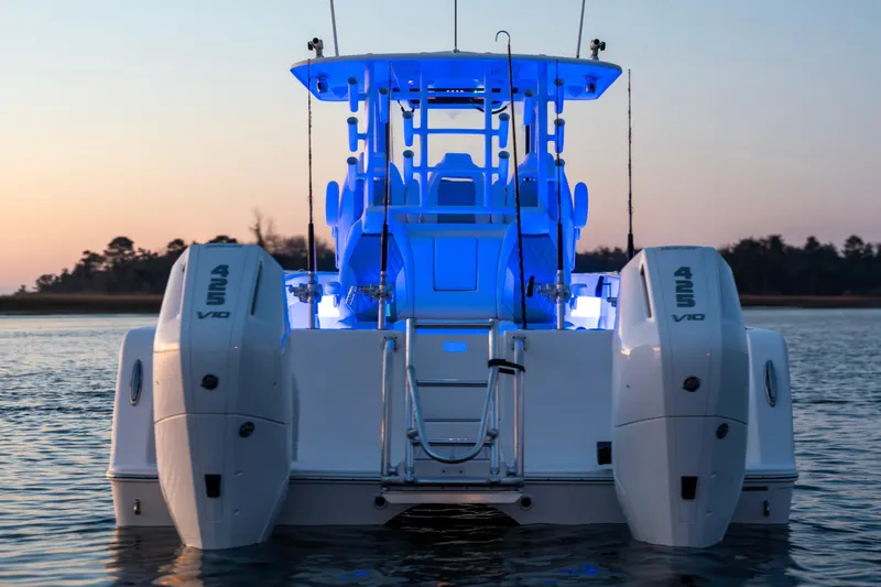 Slide: The Image of 2026 Tideline 365 Offshore boat with dual 425 V10 engines, illuminated at sunset. - 5