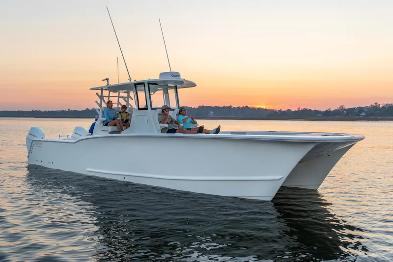 Slide: The Image of 2026 Tideline 365 Offshore boat cruising at sunset with passengers onboard. - 50