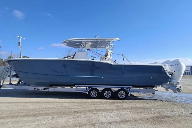 Slide: The Image of 2026 Tideline 365 Offshore boat on trailer, featuring dual Mercury engines. - 52