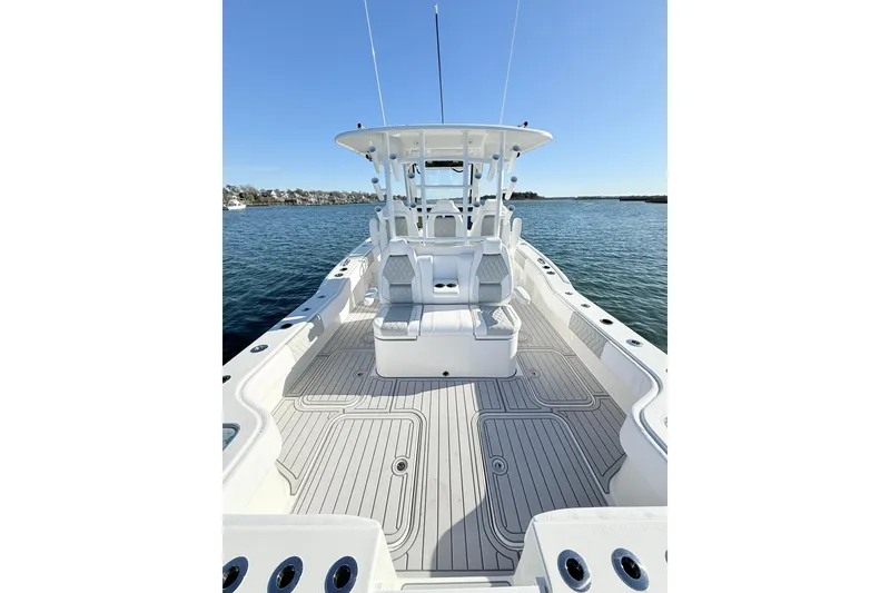 Slide: The Image of 2026 Tideline 365 Offshore boat on calm water, showcasing spacious deck and seating. - 54