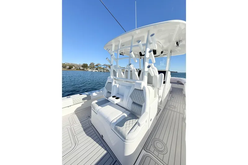 Slide: The Image of 2026 Tideline 365 Offshore boat with sleek seating and rod holders on a sunny day. - 55