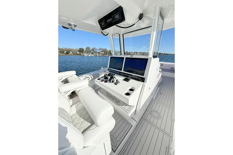 Slide: The Image of Luxurious Tideline 365 Offshore 2026 boat interior with advanced navigation system and plush seating. - 56