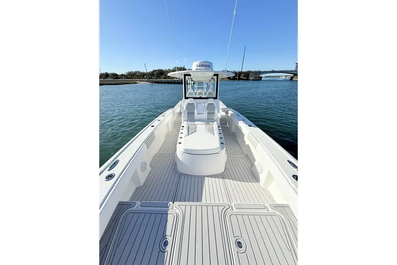 Slide: The Image of 2026 Tideline 365 Offshore boat on calm water, showcasing spacious deck and modern design. - 62