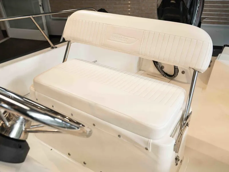Slide: The Image of Boston Whaler 150 Montauk 2014, white bench seat and steering console. - 10