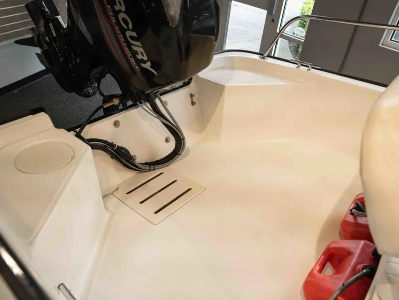 Slide: The Image of Interior of a 2014 Boston Whaler 150 Montauk with Mercury engine. - 4