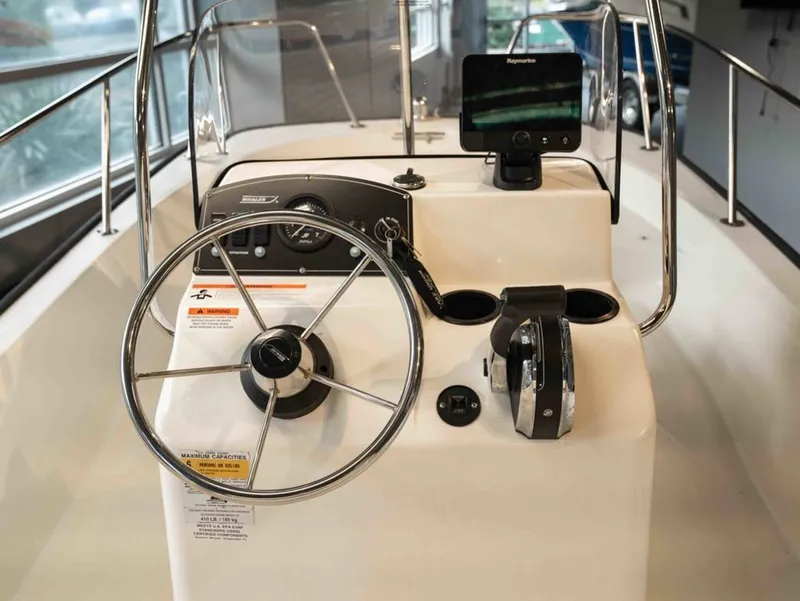 Slide: The Image of Steering console of a 2014 Boston Whaler 150 Montauk boat. - 5