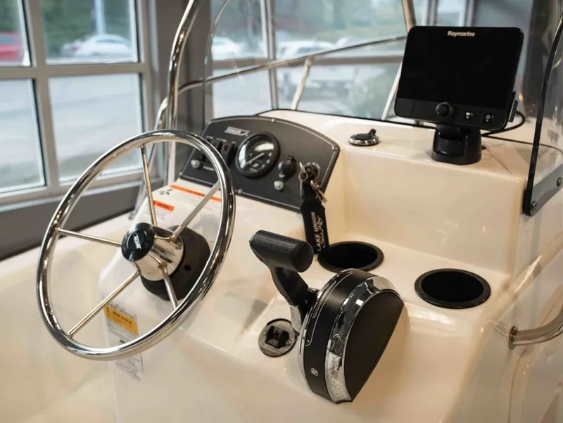Slide: The Image of Steering console of a 2014 Boston Whaler 150 Montauk boat. - 6