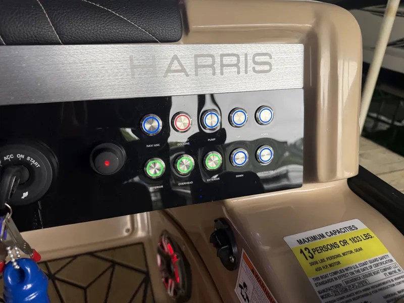 Slide: The Image of Harris 270GM 2023 boat control panel with buttons and capacity notice. - 16