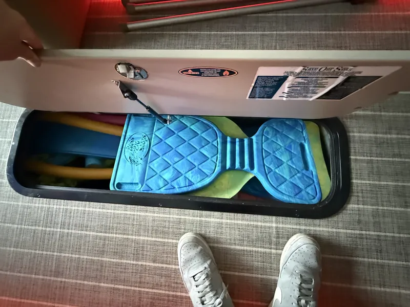 Slide: The Image of Storage compartment in Harris 270GM boat with pool noodles and mats. - 22