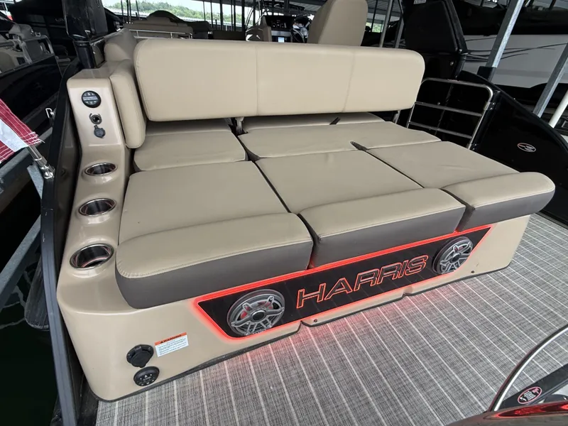 Slide: The Image of 2023 Harris 270GM boat with cushioned seating and cup holders. - 23