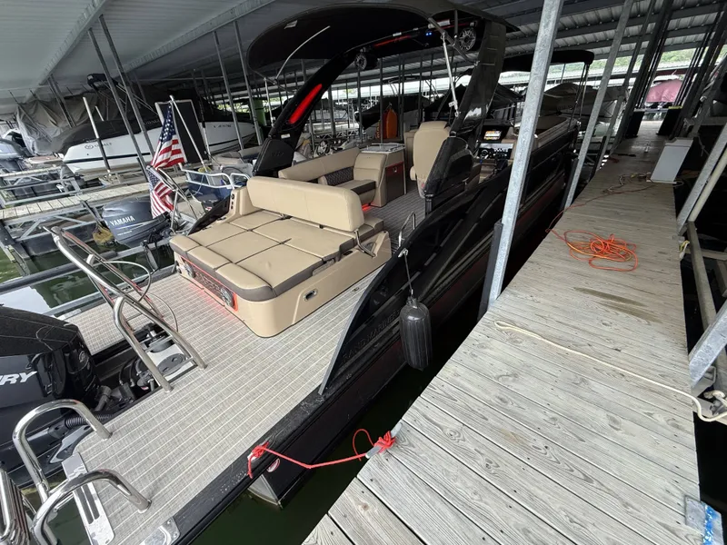 Slide: The Image of Harris 270GM boat 2023 docked with beige interior. - 24