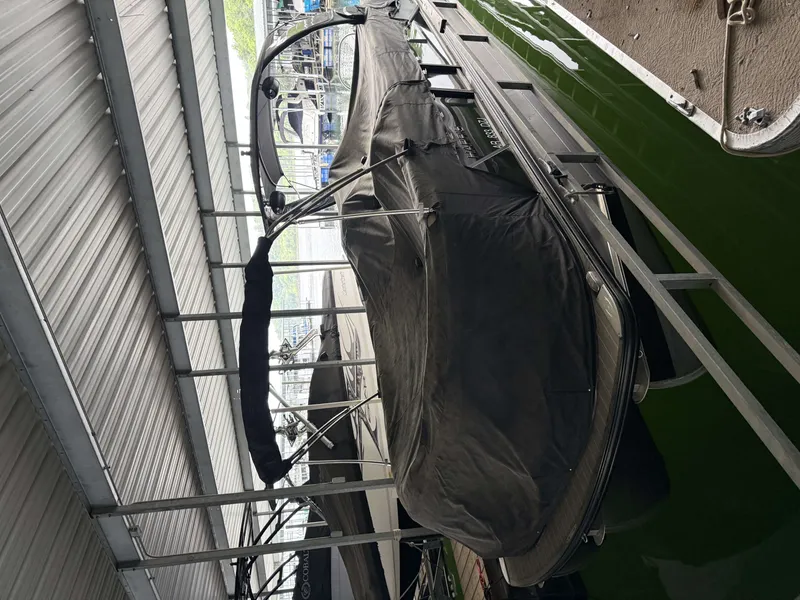 Slide: The Image of 2023 Harris 270GM boat covered in marina. - 31