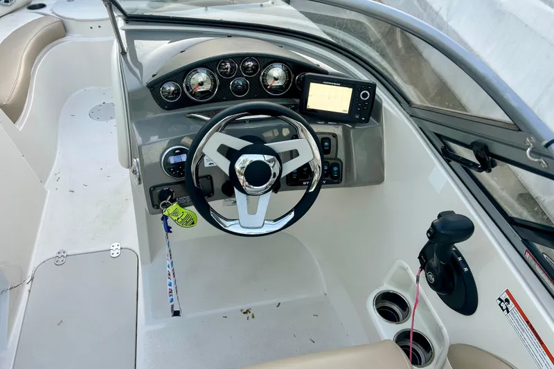 Slide: The Image of Cockpit of 2017 Stingray 204 LR boat with steering wheel and control panel. - 2