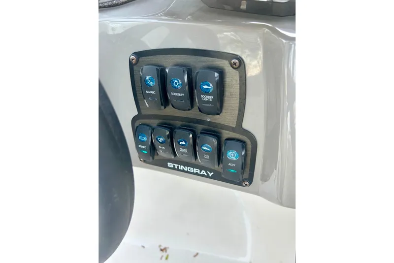 Slide: The Image of Control panel of a 2017 Stingray 204 LR boat with labeled switches. - 4