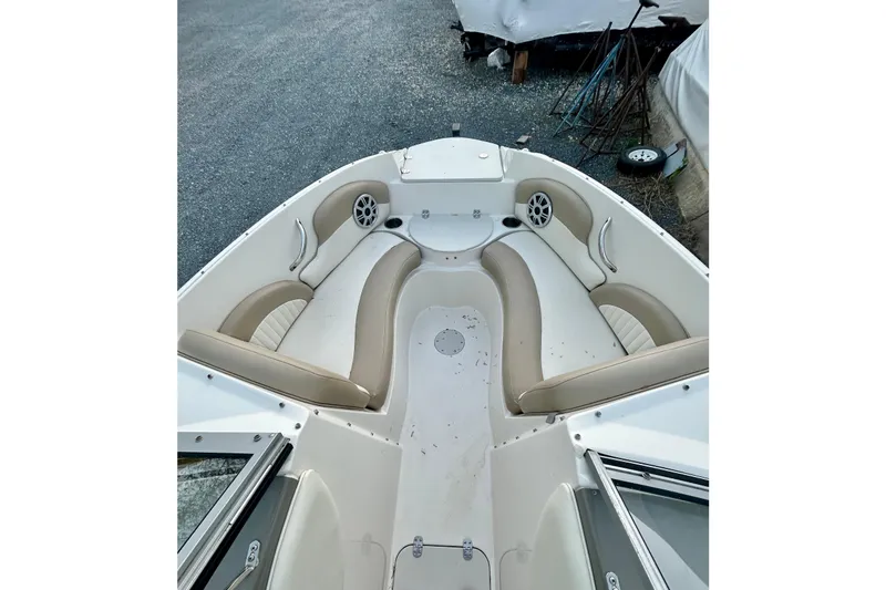 Slide: The Image of 2017 Stingray 204 LR boat interior with beige seating and speaker system. - 7